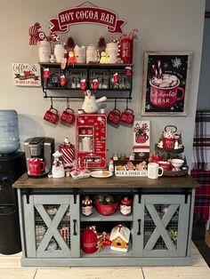 a kitchen with red and white decor on the wall, shelves above it are christmas themed items