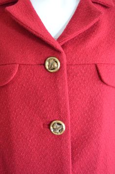 "Here is a classic 1960s skirt suit. Very Jackie Kennedy. Short jacket that hits at the waist with a matching straight skirt. Buttons up the front with pretty brass buttons and bound buttonholes. Fully lined in matching red. Skirt zips up side with a metal zipper and finishes with a hook and eye. perfect with a pair of Herbert & Beth Levine stilettos in black alligator. Label: none Condition: excellent. no flaws Measurements: JACKET Bust: 42\" Waist: 39\" Length: 18\" SKIRT Waist: 27\" Hip: Classic Notch Lapel Skirt Suit With Buttons, Classic Skirt Suit With Notch Lapel, Classic Winter Skirt Suit With Button Closure, Winter Classic Skirt Suit With Button Closure, Classic Winter Skirt Suit With Buttons, Retro Formal Skirt Suit With Buttons, Vintage Blazer With Covered Buttons For Work, Vintage Workwear Blazer With Buttons, Vintage Blazer With Buttons For Workwear