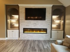 a living room with a fireplace and built in entertainment center on the wall, along with two couches