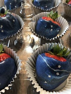 chocolate covered strawberries with stars on them are sitting in foil wrappers, ready to be eaten