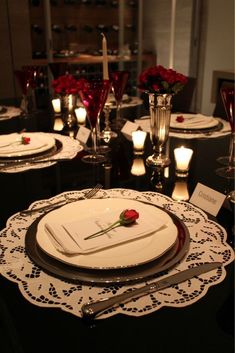 a table set with place settings and candles