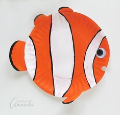 an orange and white paper plate with a clown fish on it's face,