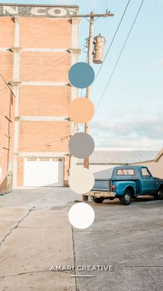 a blue truck parked in front of a tall brick building