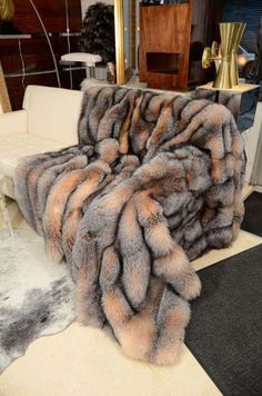 a couch covered in a large gray and brown fur