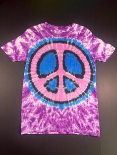 a tie dye shirt with a peace sign on it