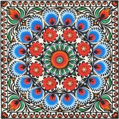 a colorful flower design on white paper with red, blue and green flowers in the center