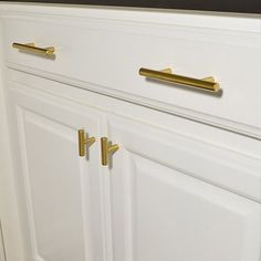 white cabinets with brass handles in a kitchen