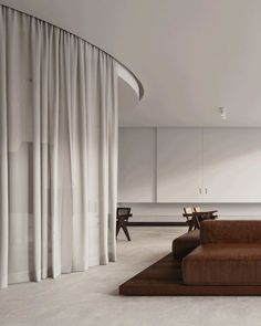 a modern living room with white walls and curtains