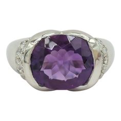 Beautiful 3.61 ct. amethyst oval and 0.41 ct. good quality white diamond rounds.  Handmade in platinum.  Ring size 7.  Metal:Platinum Stone: Amethyst,White Diamond Stone Cut: Oval Cut  Dimensions reference the ring size and are not specific to the ring itself. Exact ring dimensions are not provided. Please reach in the seller Q&A for questions. Luxury Purple Gemstones With Halo Setting, Modern Amethyst Ring With Accent Stones For Formal Occasions, Modern Amethyst Ring With Accent Stones For Formal Events, Oval Platinum Gemstone With Center Stone, Purple Diamond Gemstones With Accent Stones, Formal Round Cut Platinum Gemstones, Luxury Oval Amethyst Platinum Ring, Classic Purple Diamond Ring With Halo Setting, Elegant 14k White Gold Amethyst Ring With Center Stone