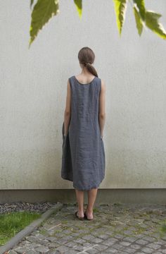 "Asymmetrical sleeveless linen tank dress with pockets for women. This summer dress has a scoop neck, loose A-shaped silhouette with asymmetrical hem line (longer at the back) and seam pockets for your comfort. The dress is light and breathable as it is made from natural Lithuanian linen. It is perfect summer holidays or celebrations. You can wear the dress loose or with one of our belts for more defined shape. Double washed for extra softness and shrinkage prevention. ABOUT US LINEN ID was born Summer Day Dresses, Sleeveless Linen Dress, Wearing Color, Summer Linen Dresses, Linen Tank, Dress Linen, Summer Linen, Oversized Dress, Linen Tunic