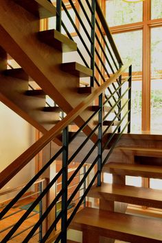 a wooden staircase with metal handrails in a home