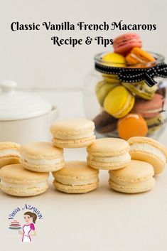 small macaroons sitting on a table next to a jar of cookies