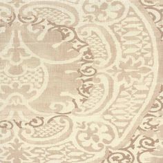 a beige and white area rug with an intricate design