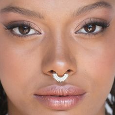 a close up of a woman's nose with a nose ring on her nose