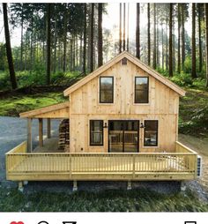 a small wooden house sitting in the middle of a forest