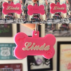 a pink dog tag with the name linda on it is being held by someone's hand