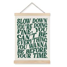 a green and white wall hanging with the words slow down you're doing fine