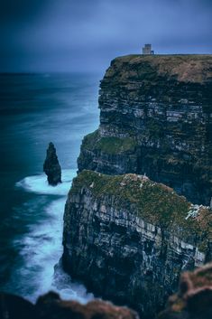 the cliffs are covered in moss and water