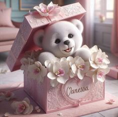 a white teddy bear sitting in a pink box with flowers on the bottom and name