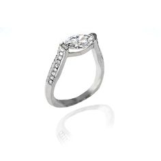 a white gold ring with diamonds on the sides and an oval shaped diamond in the center