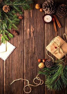 christmas decorations and pine cones on a wooden table