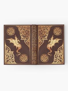 an intricately decorated book with gold dragon on the front and sides, in brown leather