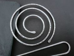 This spiral bun cage is handmade with thick gauge sterling silver wire, hammered and oxidized to emphasize all the details. The spiral comes with a fork, but the fork can also be purchased and used separately. You can choose between three bun holder sizes, 6 cm diameter (2.4 inches), 8 cm diameter (3.1 inches) and 10 cm diameter (4 inches). The forks are 1 inch (2.5 cm) longer than the spiral. If you have thinner smaller hair and you need a smaller size or if you have really thiker long hair you Metal Hair Bun Cage, How To Clean Silverware, Metal Hair Stick, Metal Hook Bookmark, Dishwashing Liquid, Hair Barrettes, Silver Hair, Hair Comb, Comb