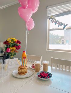 a table topped with pancakes and balloons