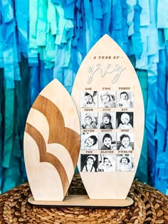 two wooden surfboards sitting on top of a wicker basket next to a blue wall