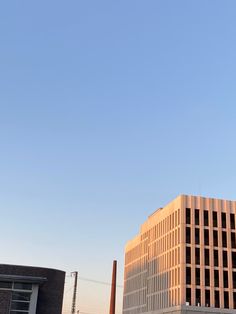 an airplane flying in the sky over some buildings