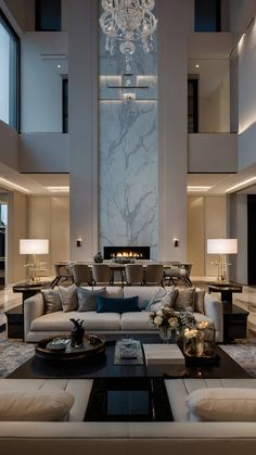 a living room filled with furniture and a fire place in the middle of it's wall