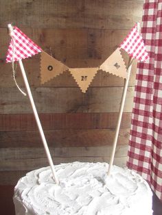 a cake with two red and white checkered flags sitting on it's side