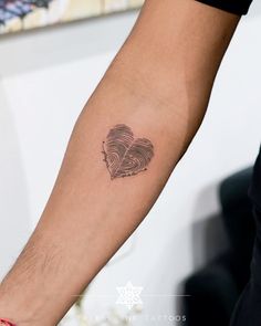 a person's arm with a fingerprint in the shape of a heart on it