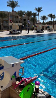 an empty swimming pool with diving equipment on the edge