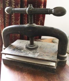 an old fashioned phone sitting on top of a wooden table next to a red rug