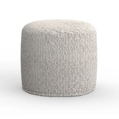 a small white ottoman sitting on top of a floor