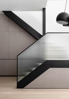 an empty room with wooden floors and glass railings on the wall next to it