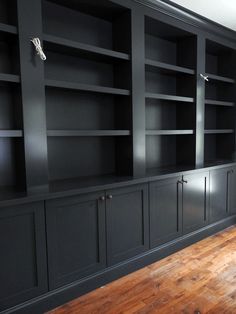 black bookcases with wooden floors and wood flooring