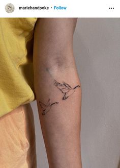 a person with a bird tattoo on their arm