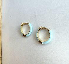 Enamel Mini Huggie Hoop Earrings, Huggie Hoop Earrings, Gold Huggie Earrings For the latest deals, follow Sweet Geneva: Instagram - @sweetgenevacrafts  Due to the handmade nature of these items as well as lighting, items may vary slightly.  Jewelry Care-store jewelry in a safe, dry place.   Avoid wearing jewelry while bathing or in the ocean/pool. As raw brass and other metals are exposed to the elements they patina.  This brings out their natural beauty!  Lemon juice can be used to make raw bra Luxury Blue Huggie Jewelry, Ocean Pool, Gold Huggie Earrings, Wearing Jewelry, Store Jewelry, Hoop Earrings Gold, Huggie Earrings, In The Ocean, Huggie Hoop Earrings