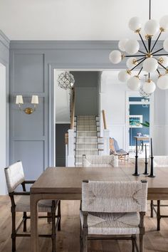 a dining room table with chairs and a chandelier