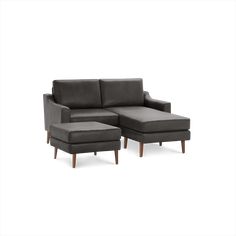 a gray couch and ottoman sitting next to each other