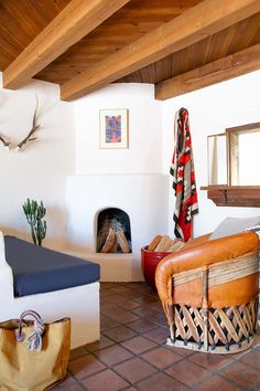 a living room filled with furniture and a fire place next to a wall mounted clock