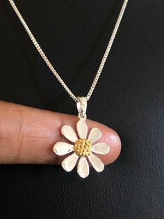 "Dainty Daisy Necklace, Sterling Silver Daisy Pendant, NECKLACE FEATURES: Metal: All components are made from solid .925 Sterling Silver Model is wearing 16\" in length solid .925 Sterling Silver Chain Length available: 16\", 18\" or 20\" Measurements: 18K Yellow Gold Plated over solid .925 Sterling Silver Daisy Pendant Height: 26.2MM Width: 19.05MM Petals: Solid .925 Sterling Silver Center Flower: 18K Yellow Gold Plated over solid .925 Sterling Silver Your Dainty Daisy Flower Necklace will arri White Flower Charm Necklace, White Flower Necklace For Mother's Day, Handmade Flower Necklace For Anniversary, White Flower Pendant Necklace For Mother's Day, White Flower Charm Necklace Handmade, White Flower Necklaces For Mother's Day, White Flower Shaped Necklace With Flower Charm, Handmade White Daisy Necklaces, White Daisy Shaped Necklace For Gift