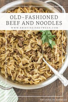 an old - fashioned beef and noodles dish in a white bowl with a serving spoon