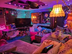 a living room filled with lots of furniture and colorful lights on the ceiling above it