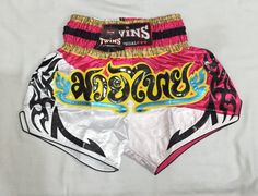 a pair of pink and white shorts with writing on them