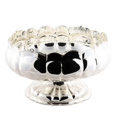 a silver bowl with black and white decorations on it's sides, in the shape of a flower