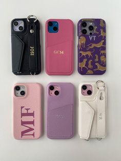 four cell phones sitting next to each other on top of a white surface with an animal print