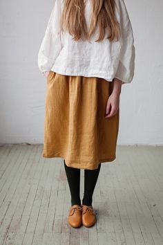 Below the knee skirt is made from 100% soft and washed linen. This Petticoat is perfect for wearing under dress or other skirt or can be worn alone. Match it with our tunics! Details: - Composition: 100% Oeko-Tex certified linen - Colour: mustard yellow - Elastic waist - Pockets - Size: One size/fits all - Medium weight linen - Linen care: machine wash gentle; tumble dry low, ironing optional - The price is for one skirt, other pictured items are not included Relaxed Fit Gathered Midi Skirt, Relaxed Fit Flared Skirt For Fall, Fall Season Relaxed Fit Flared Skirt, Relaxed Fit Long Gathered Skirt, Long Gathered Skirt With Relaxed Fit, Relaxed Fit Pleated Skirt, Relaxed Fit Skirt With Elastic Waistband, Fall Lined Skirt, Relaxed Fit Mini Skirt With Lining